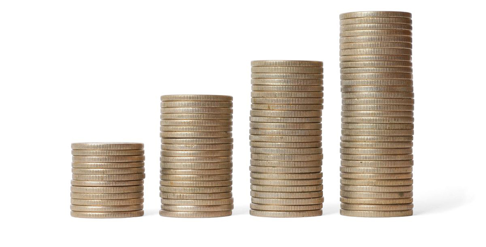 Stacks of coins increasing in height from left to right, representing growing savings or financial growth on a white background.