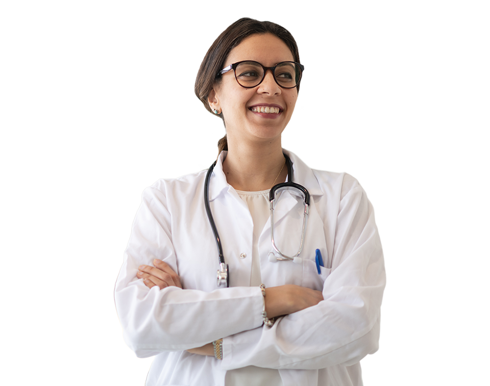 Smiling female doctor with glasses in a white coat and stethoscope, arms crossed in a clinical setting.