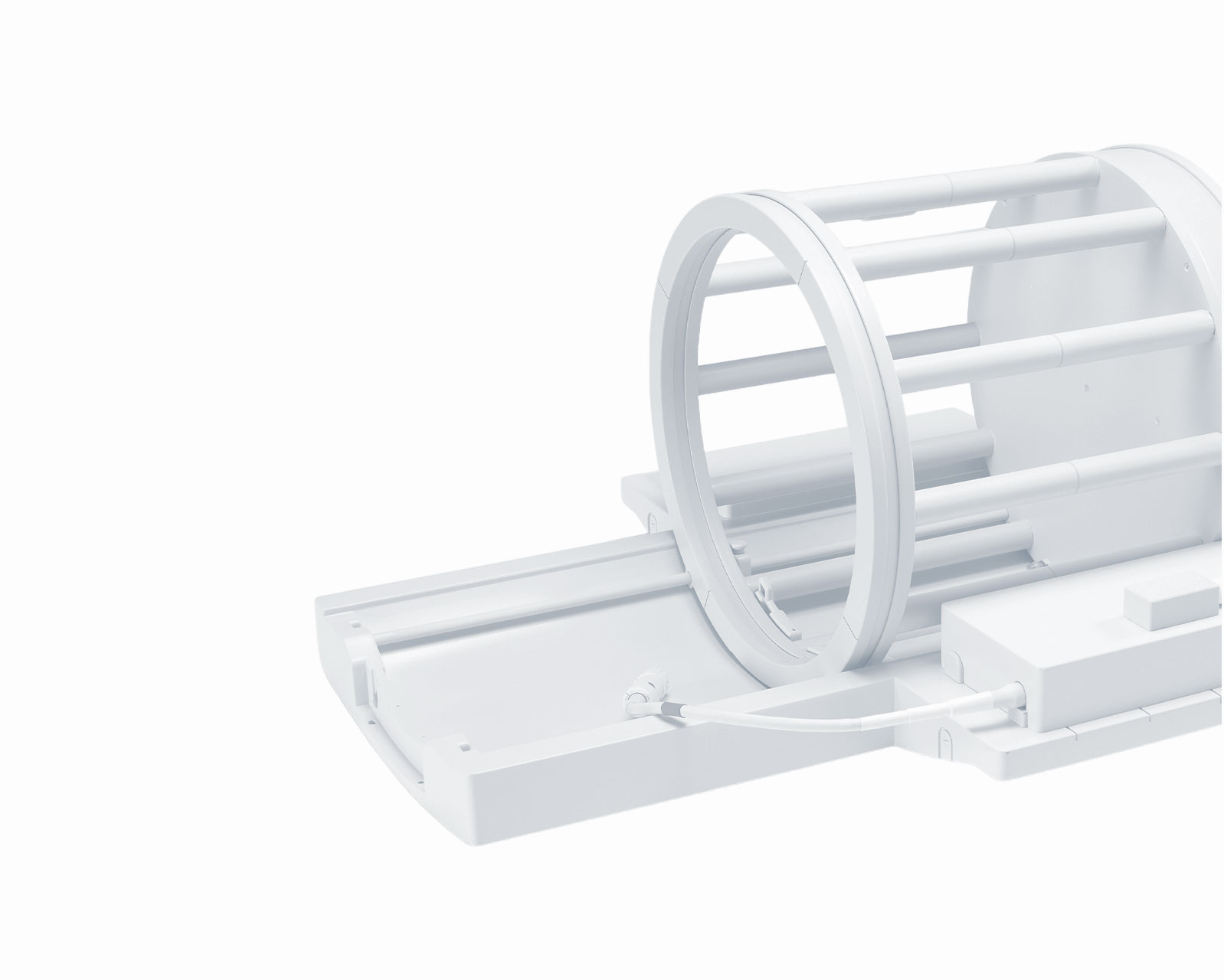 Circular MRI scanner bore with a flat patient table on a white background, showing the imaging ring and support rails.