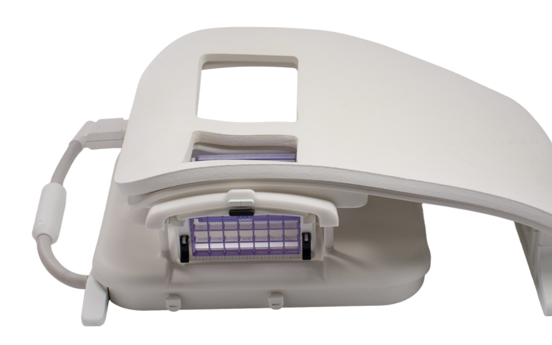 White medical phototherapy lamp with hinged cover; purple light panel exposed inside the housing
