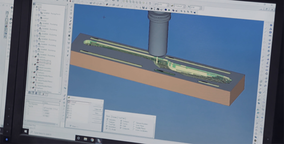 Screenshot of CAD software displaying a long brown block with a vertical pipe and internal green components inside a blue viewport; toolbars visible around the workspace.
