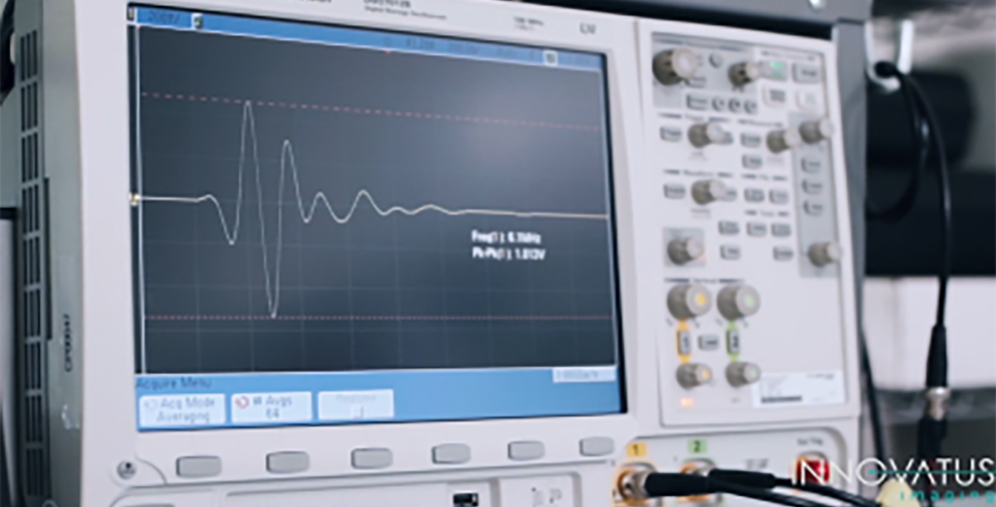 Oscilloscope displaying a waveform on its screen with a control panel and knobs on the right side