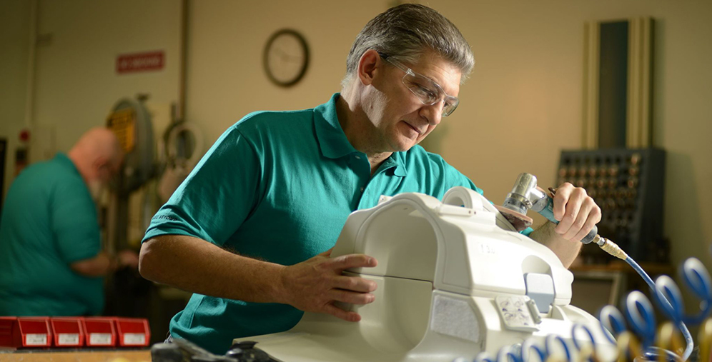 man repairing an mri coil