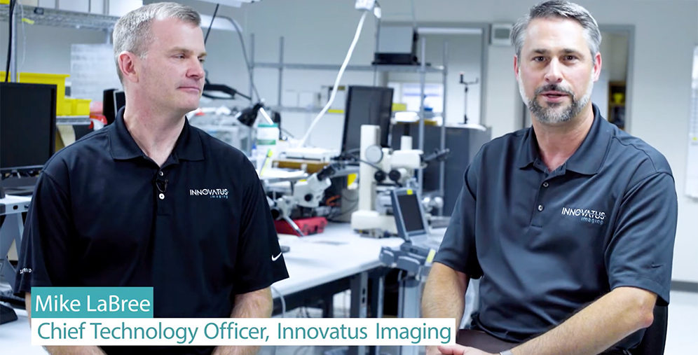 Two men in a lab wear black Innovatus Imaging polo shirts, seated at a workbench with equipment in the background; overlay reads 'Mike LaBree, Chief Technology Officer, Innovatus Imaging'