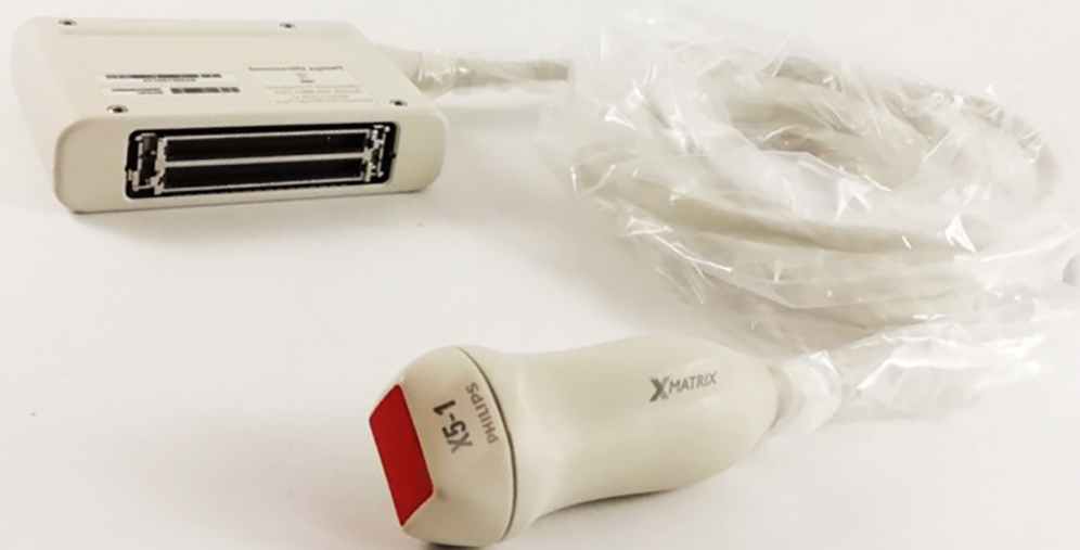 Medical ultrasound transducer (probe) with a connected cable on a white surface, ready for diagnostic imaging.