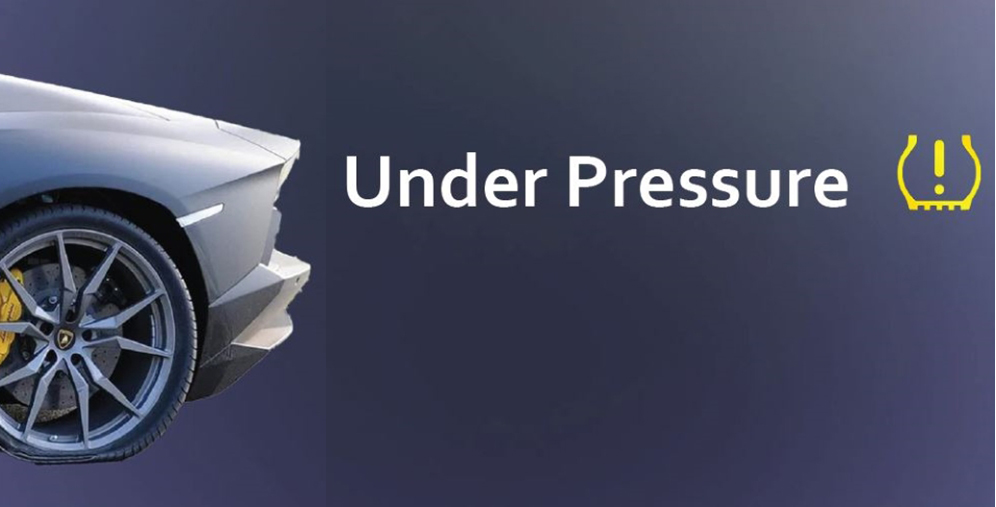 Front left section of a silver sports car with a visible wheel, paired with the words 'Under Pressure' and a yellow warning icon on a dark blue gradient background